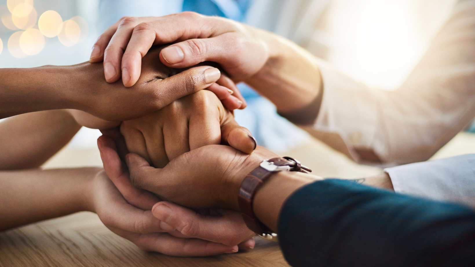 Diverse hands holding onto each other