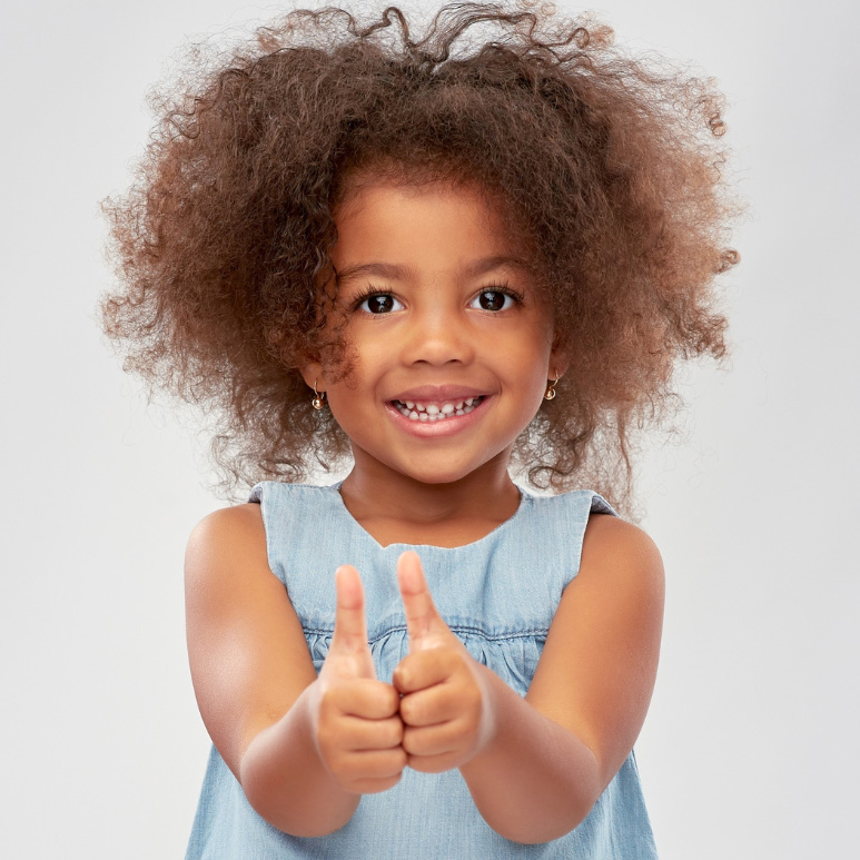 Black girl with 2 thumbs up smiling at camera